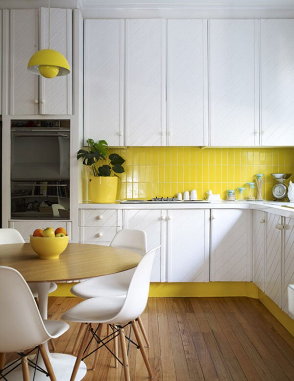 white kitchen cabinets with yellow backsplash